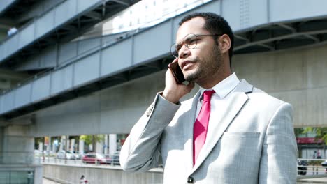 Professional-businessman-talking-by-smartphone